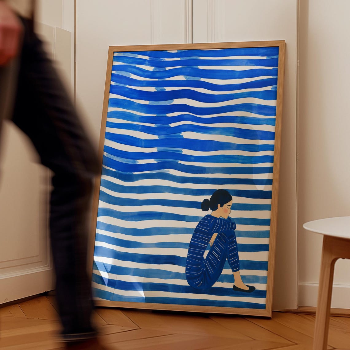 Woman Seated Among Bold Blue Waves in Striped Clothing Poster - Image 2