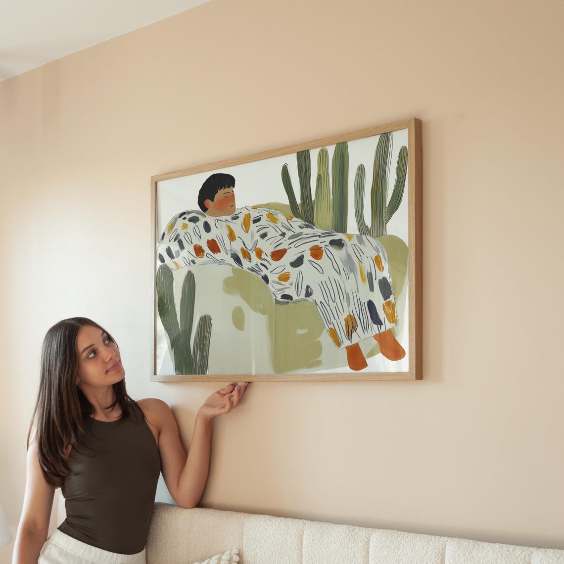 Person Resting on Green Couch Surrounded by Tall Cacti Poster - Image 5