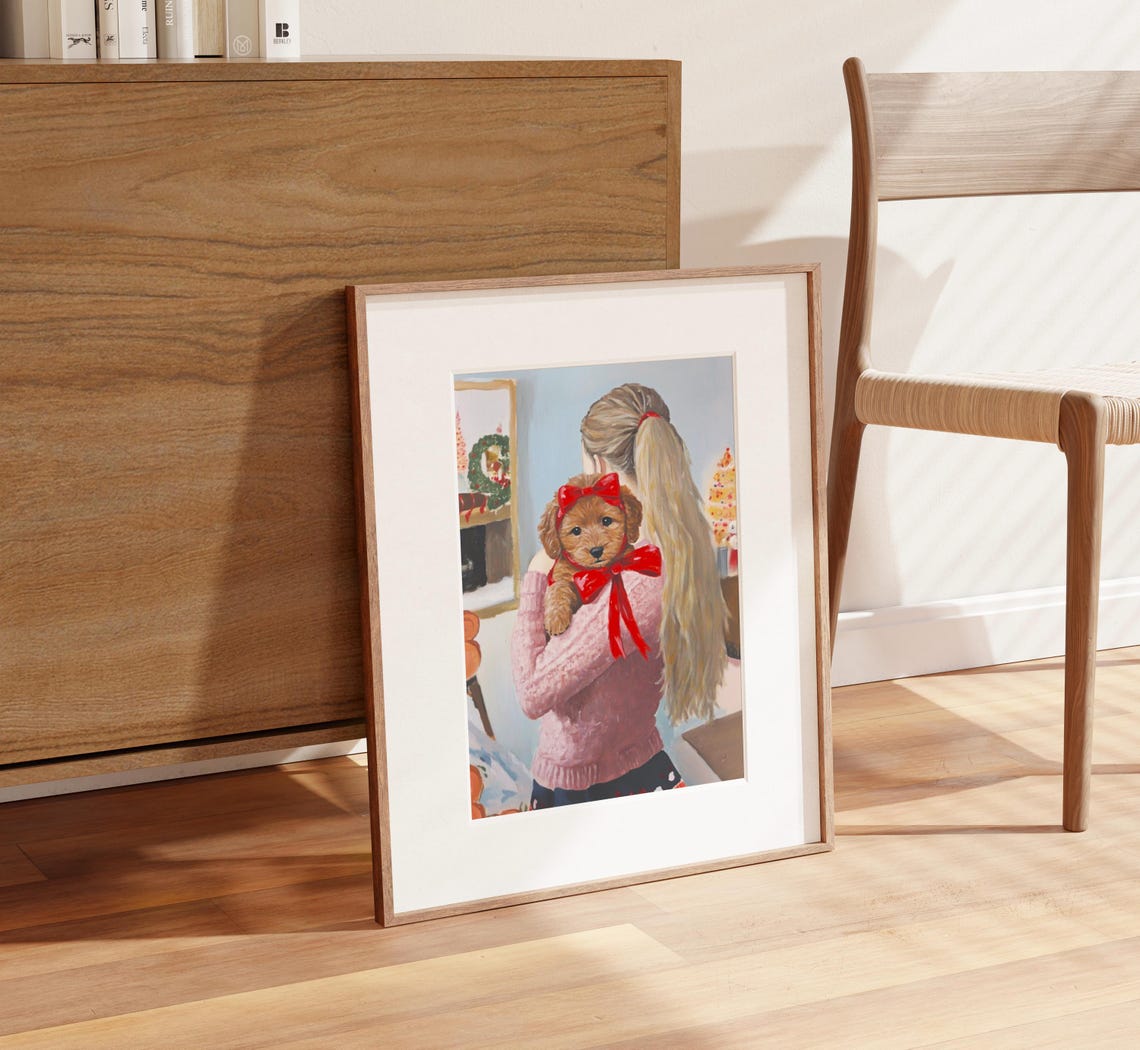 Girl Holding Goldendoodle Puppy with Red Bow by Fireplace Poster - Image 2