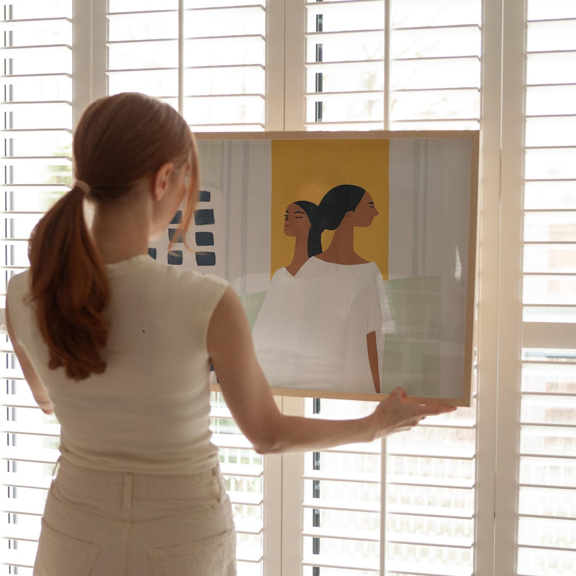 Two Women in White Standing Against Colorful Abstract Panels Poster - Image 5