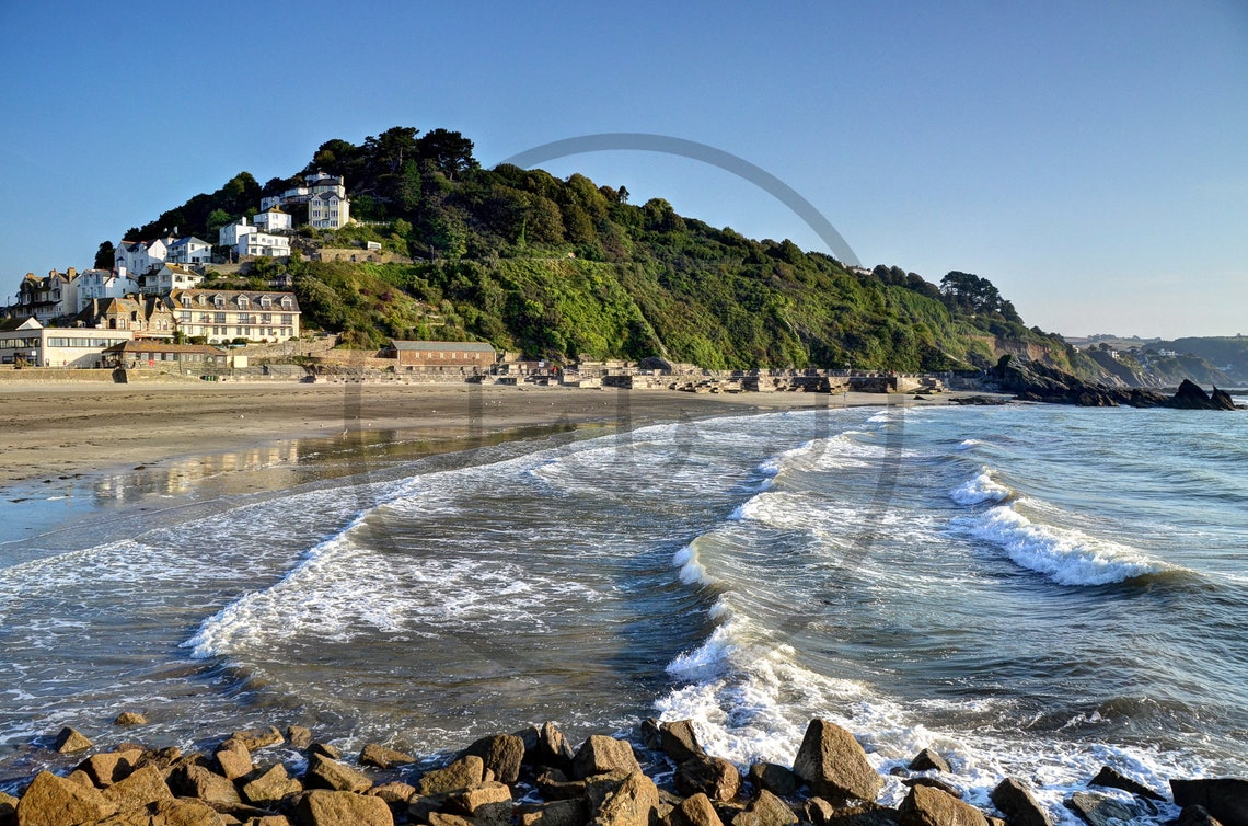 White Waves Breaking on Rocky Shores Below a Clifftop Village Poster - Image 3