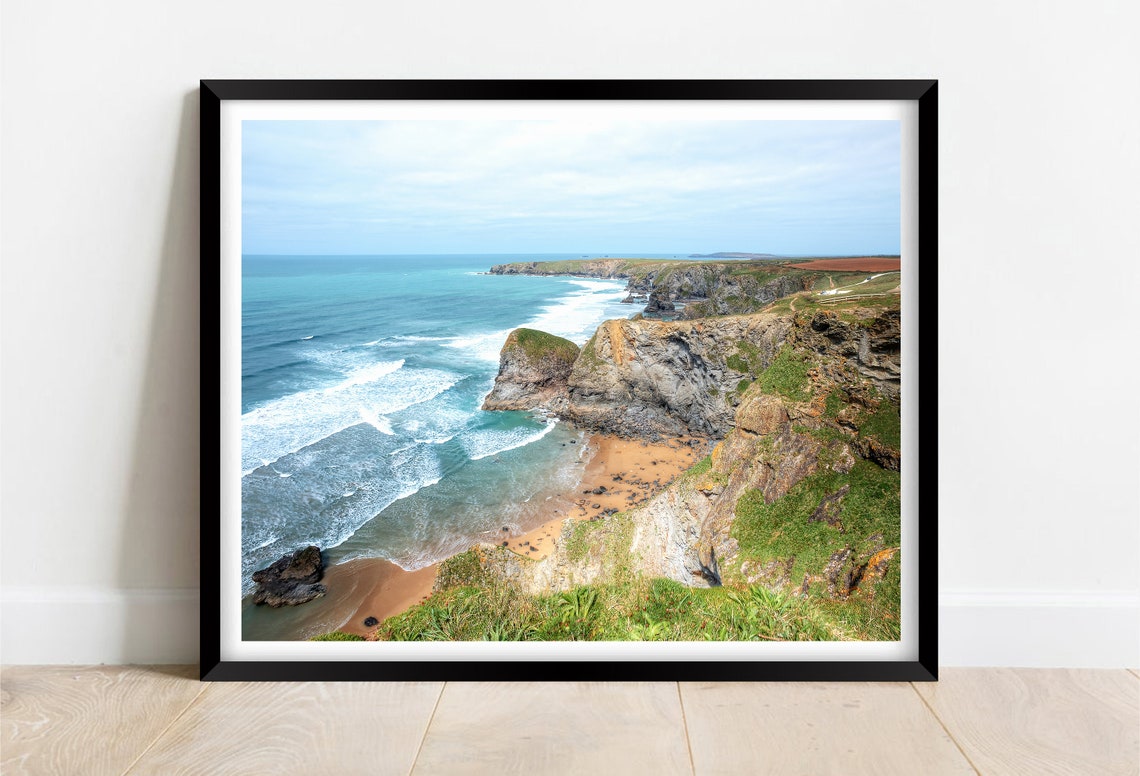 Dramatic Sea Cliffs with Turquoise Waves and Sandy Cove Poster