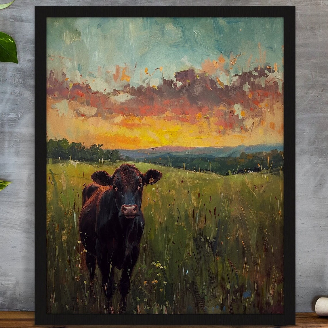 Black Cow in a Green Pasture Under a Beautiful Glowing Sunset Poster