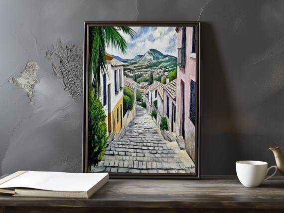 Cobblestone Lane Between White Houses Toward A Mountain Poster