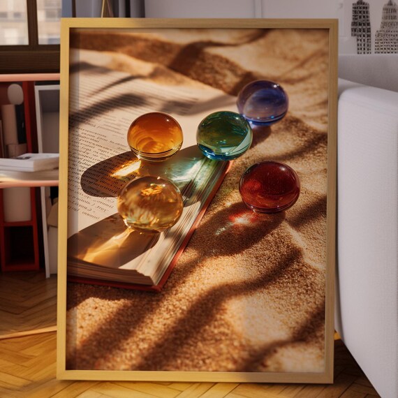 Colorful Glass Orbs on Open Book in Golden Beach Sand Poster