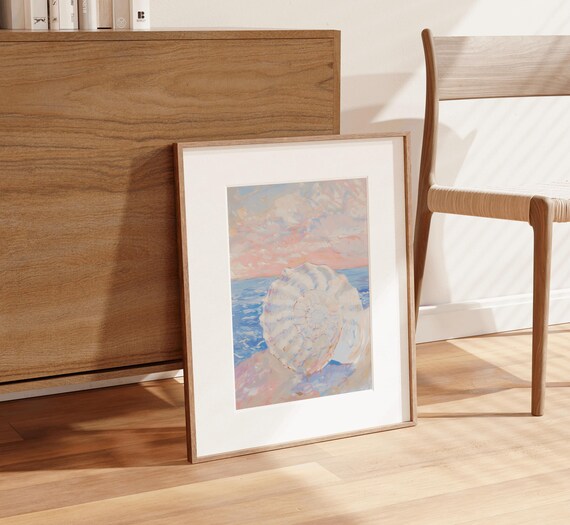 White Seashell Resting On Shore Under Pink Sunset Sky Poster