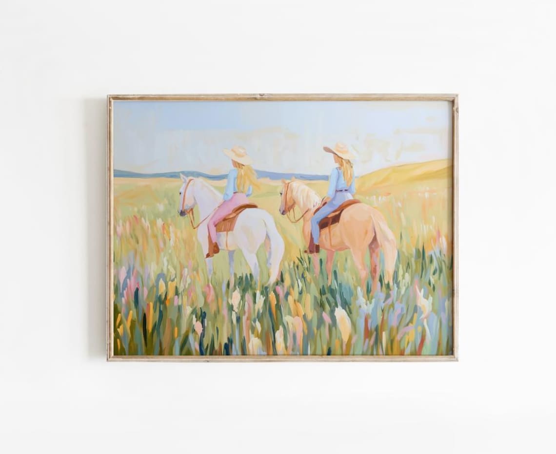 Two Cowgirls Riding Horses Through a Wildflower Meadow Art Poster