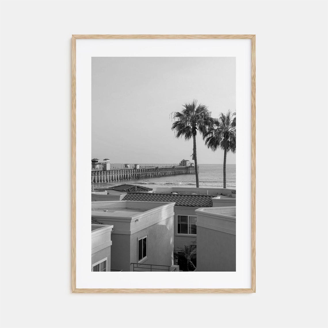 Ocean Pier Viewed From Coastal Town Rooftops Black White Poster