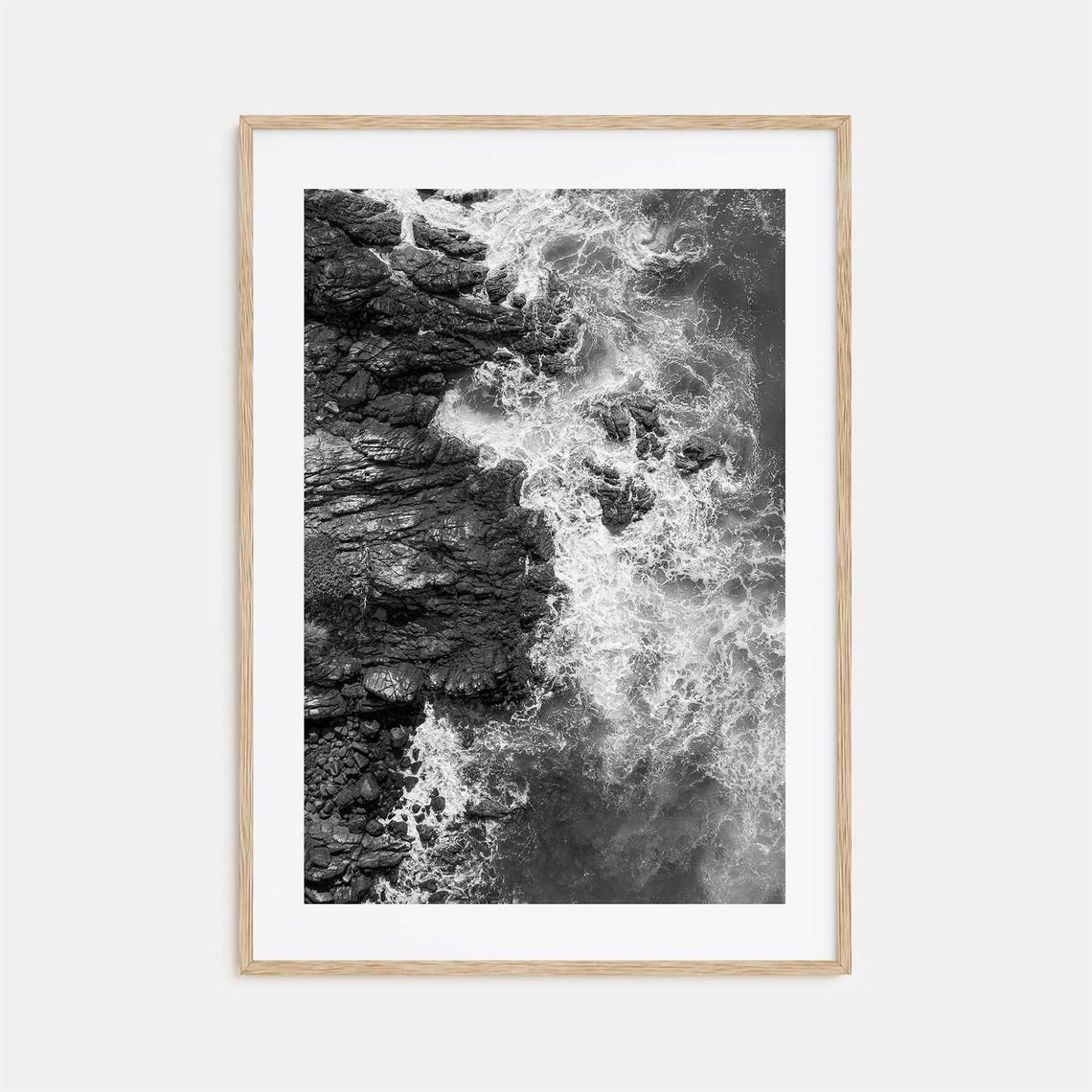 Ocean Waves Crashing Over Dark Rocky Shoreline Aerial Poster