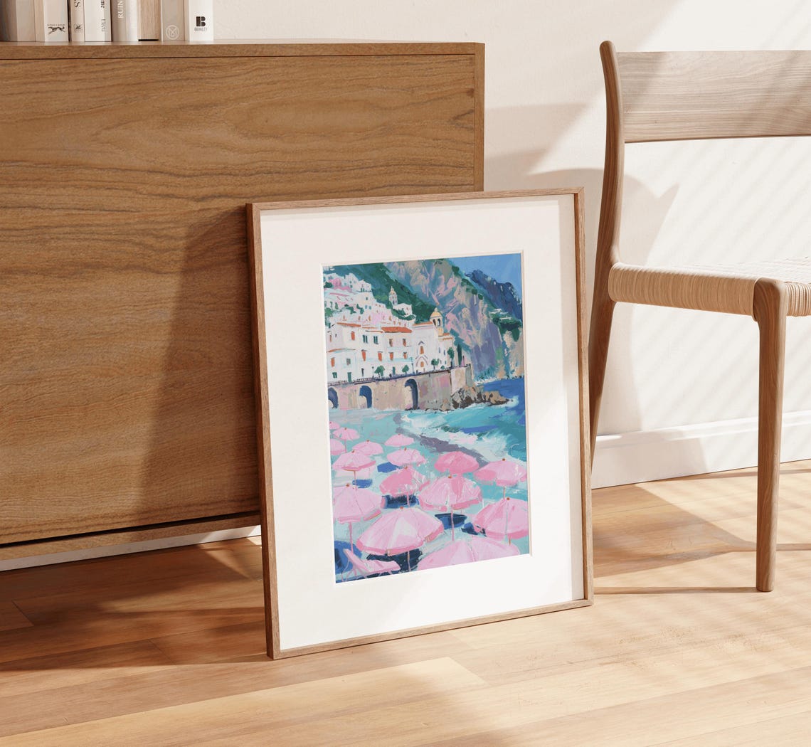 Sunlit Mediterranean Cliff Town With Pink Beach Umbrellas Poster - Image 3