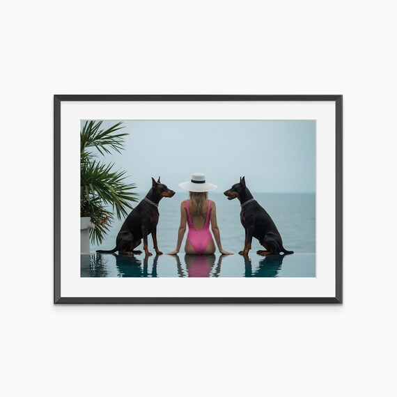 Two Doberman Pinschers with Woman by Infinity Pool Lifestyle Poster