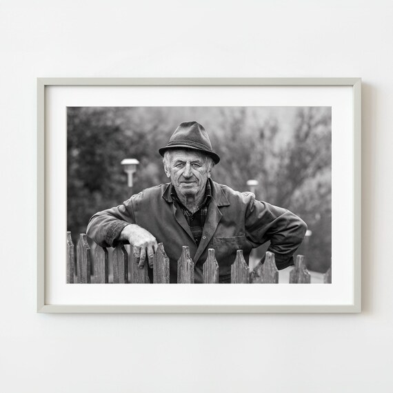 Black And White Portrait Of A Weathered Farmer Leaning On Fence Wall Art