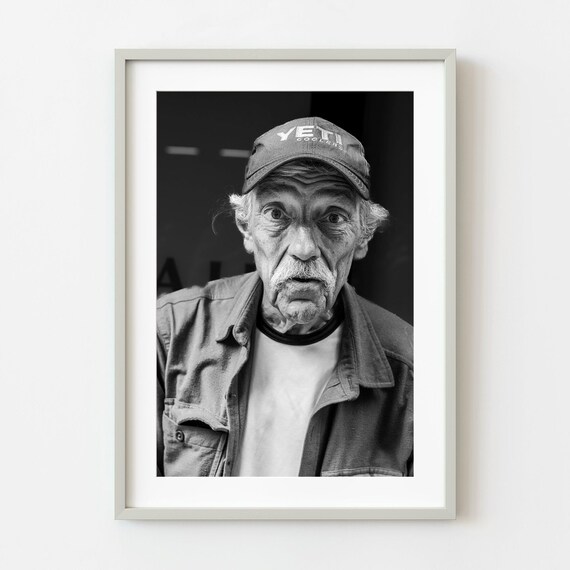 Black and White Street Portrait of an Older Man in a Cap Poster