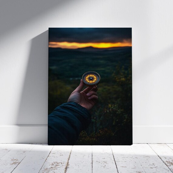 Hand Holding Vintage Compass Over Hills At Golden Sunset Wall Art
