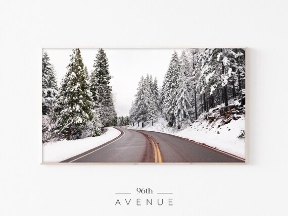 Winding Mountain Road Through Snow Covered Evergreen Forest Poster