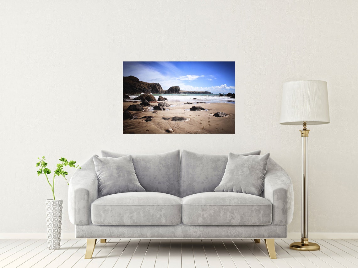 Rocky Beach Cove with a Towering Sea Stack Under a Blue Sky Poster - Image 2