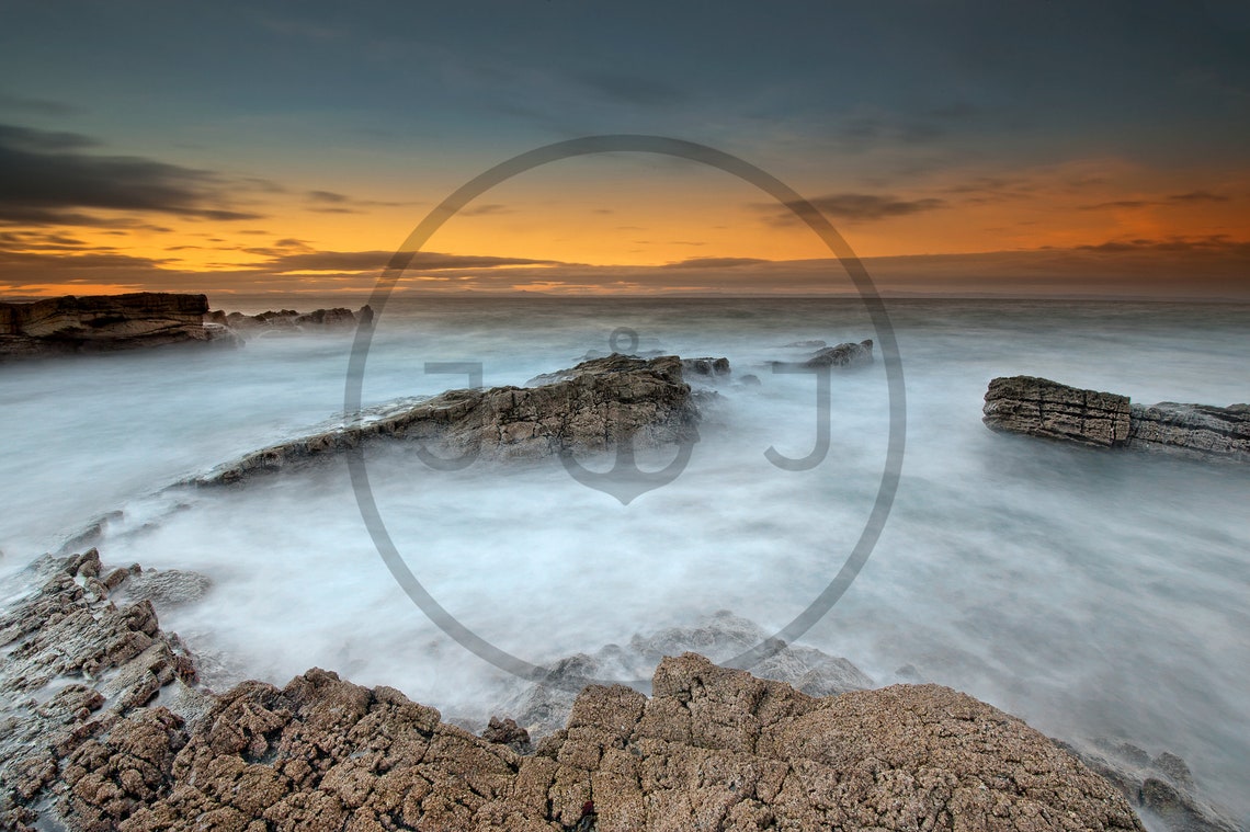 Long Exposure Waves Washing Over a Rocky Shore at Sunset Poster - Image 3