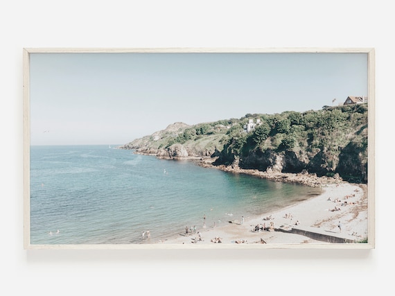 Sunlit Beach Cove With Swimmers And Rocky Cliffs Photo Poster