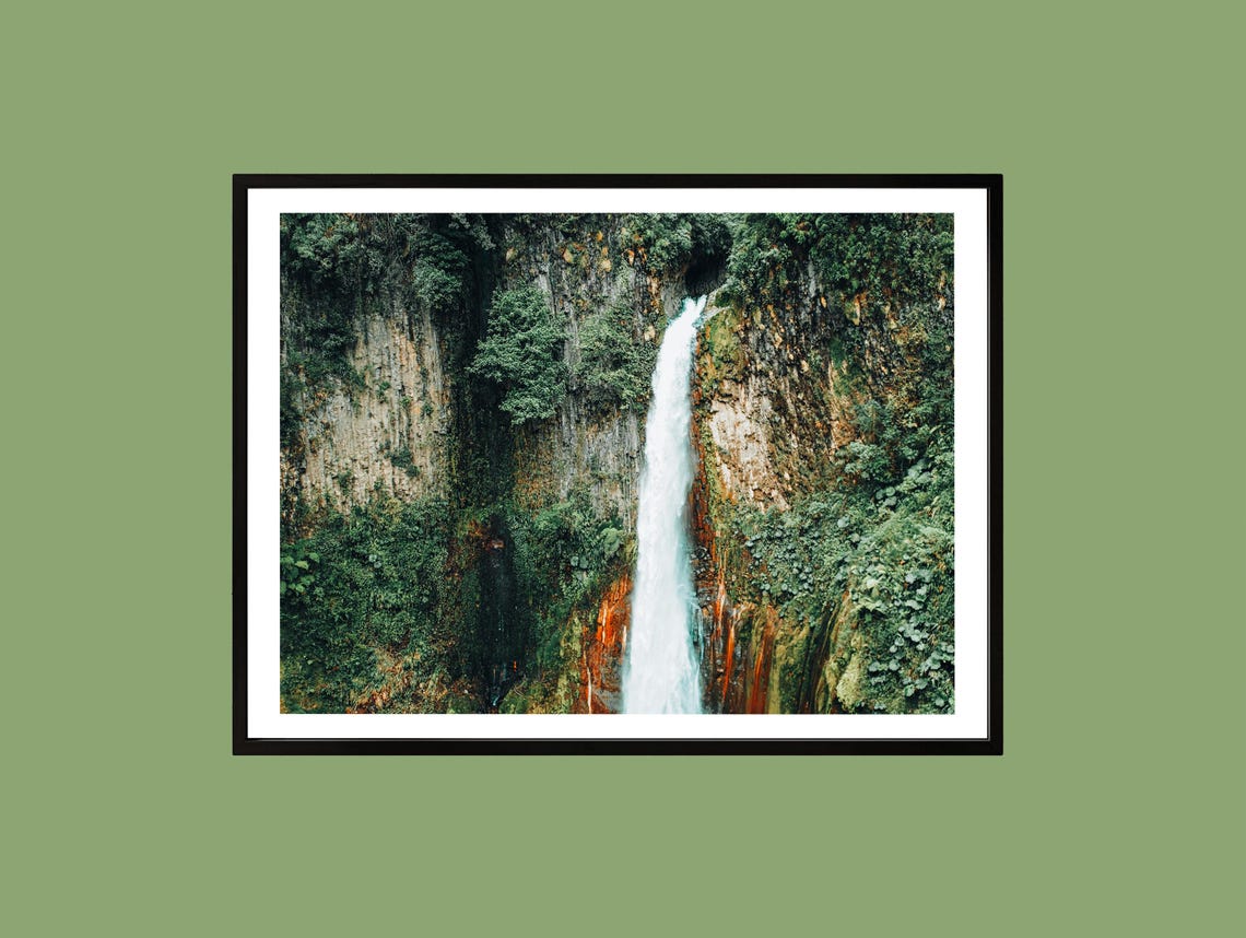 Tall Waterfall Cascading Down a Mossy Cliff in the Rainforest Poster