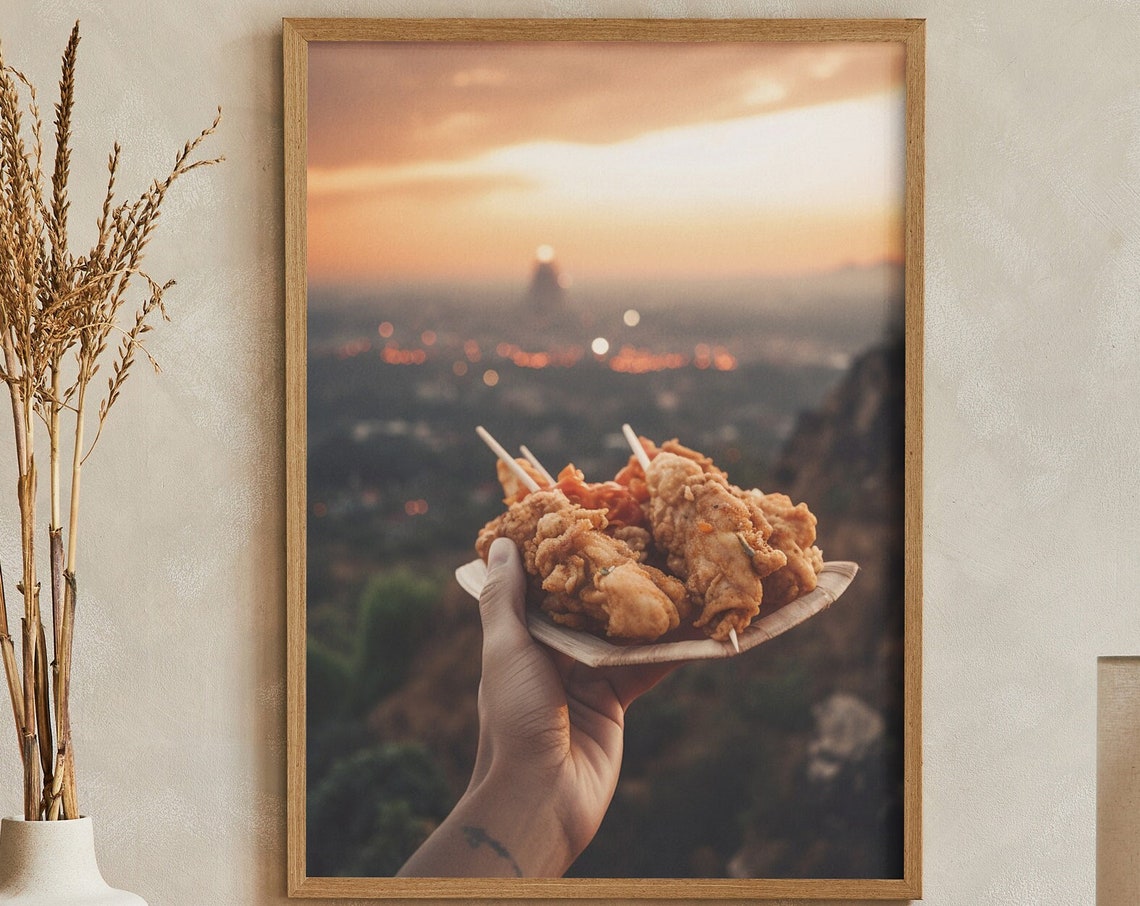 Crispy Fried Chicken Skewers Held Over A City Sunset View Poster