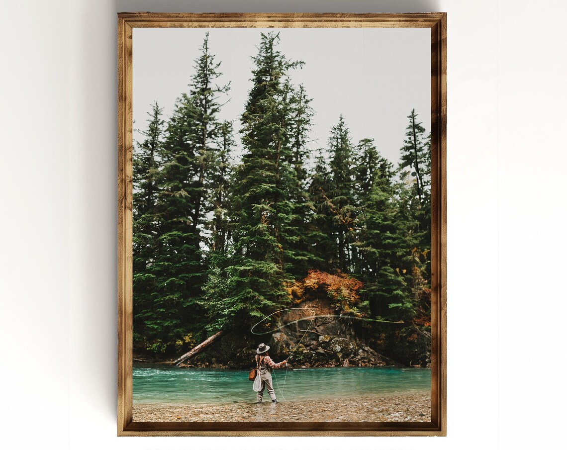 Fly Fisherman Casting in a Turquoise River Under Evergreens Poster