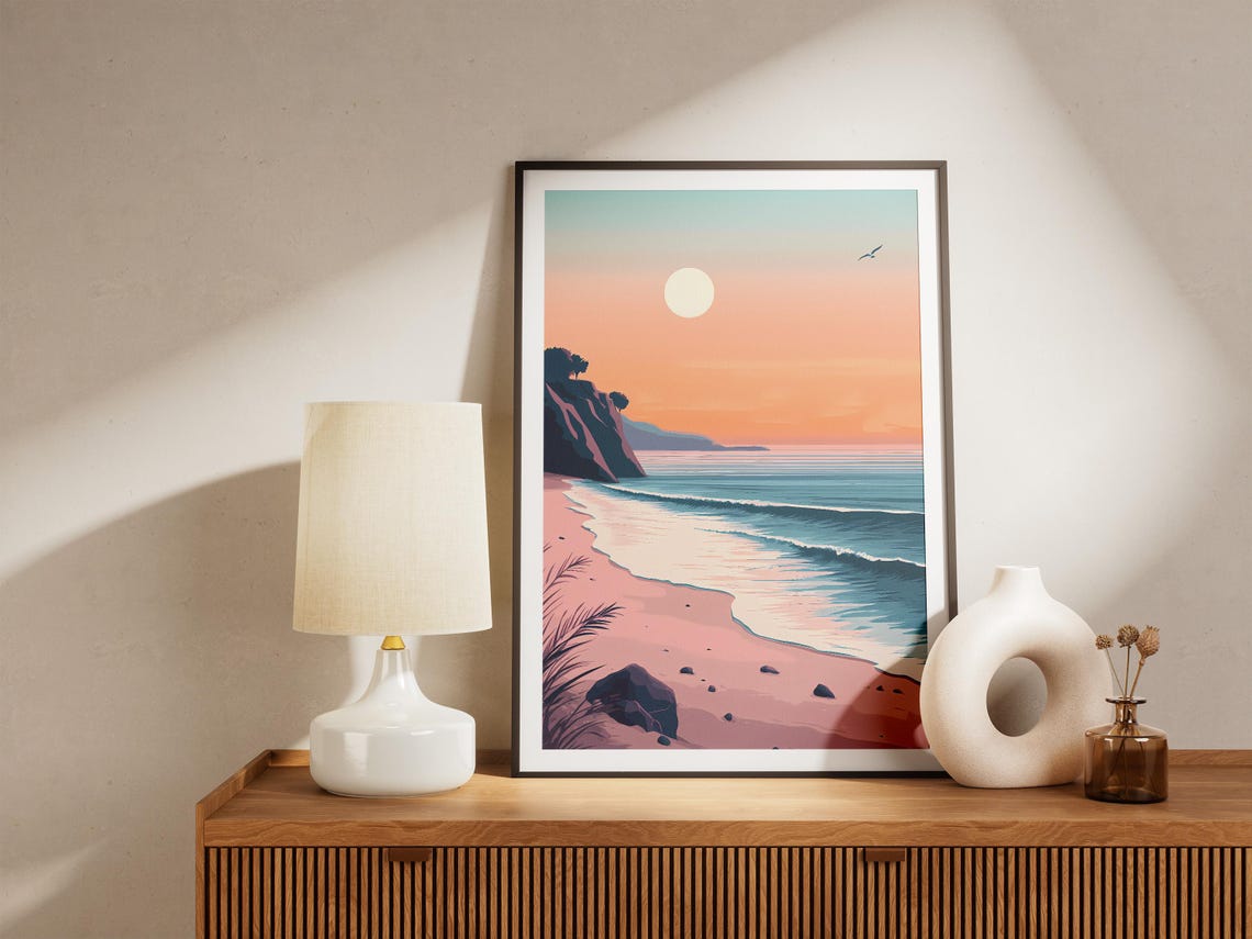 Soft Pink Sunrise Over a Curved Beach with Rocky Cliffs Poster - Image 5