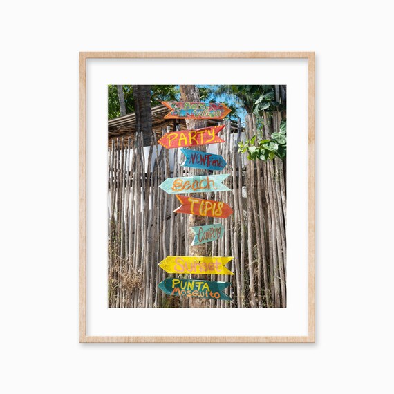 Colorful Hand Painted Wooden Direction Signs at a Beach Spot Poster