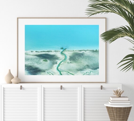 Aerial View of a Turquoise Tidal Channel Through Sandy Flats Poster