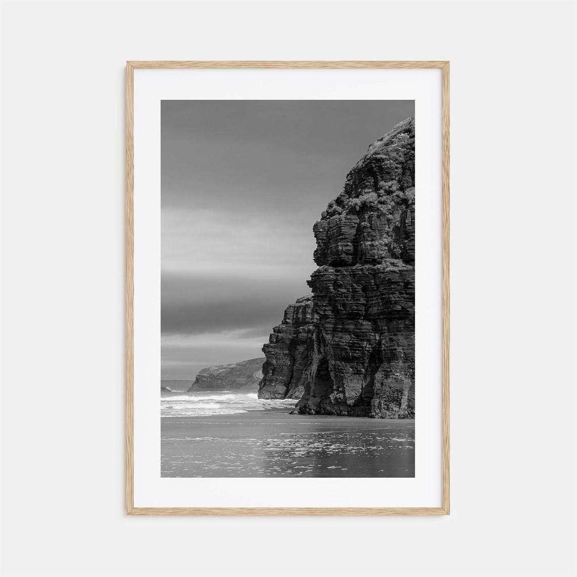 Towering Sea Cliffs Over A Wild Beach Black And White Poster