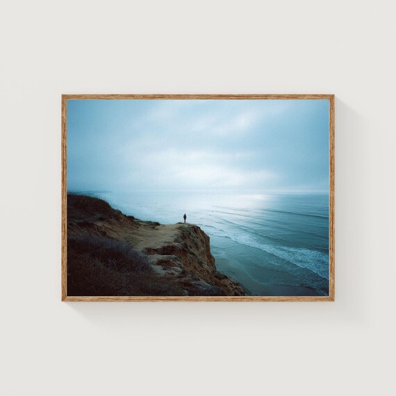 Lone Figure on Ocean Cliff Edge Moody Blue Waves Seascape Poster