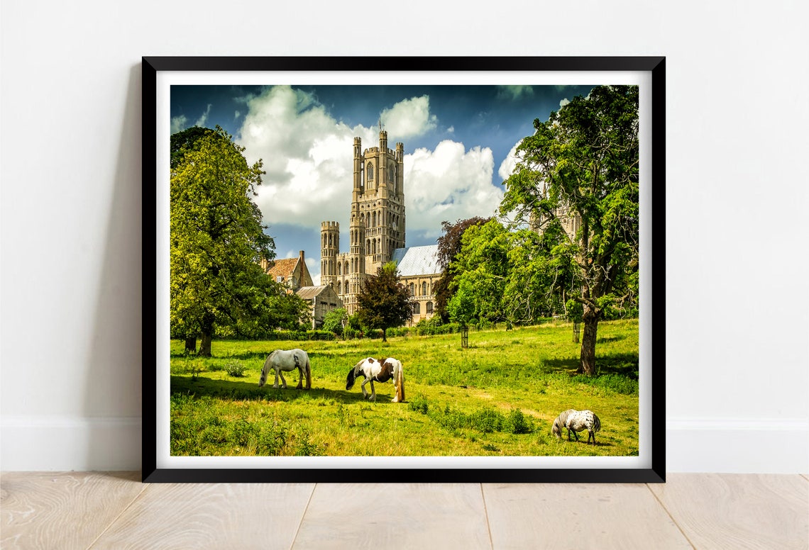 Ely Cathedral Towering Over a Meadow With Grazing Horses Poster