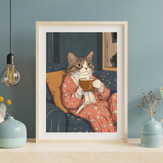 Cozy Tabby Cat in Pajamas Drinking Coffee on a Blue Sofa Poster