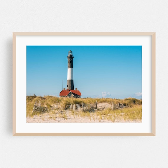 Classic Black and White Striped Lighthouse on Sandy Dunes Poster