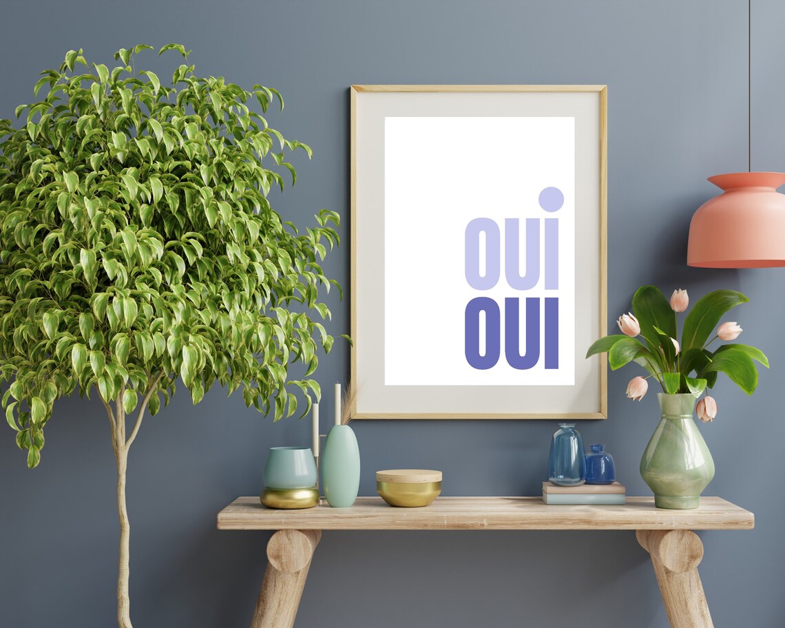 Oui Oui French Typography Poster In Lilac And Blue On A White Wall - Image 2