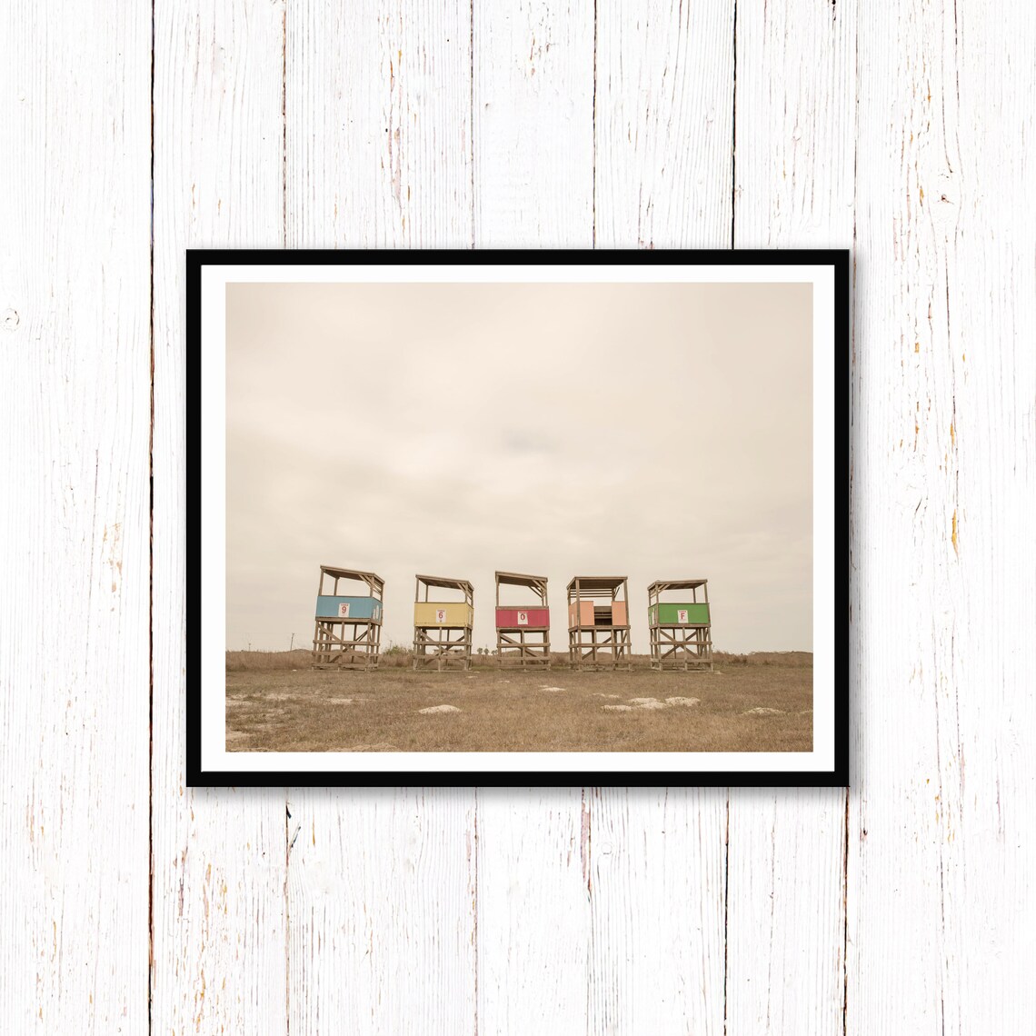 Row of Colorful Lifeguard Towers on a Beach Under Grey Sky Poster - Image 2