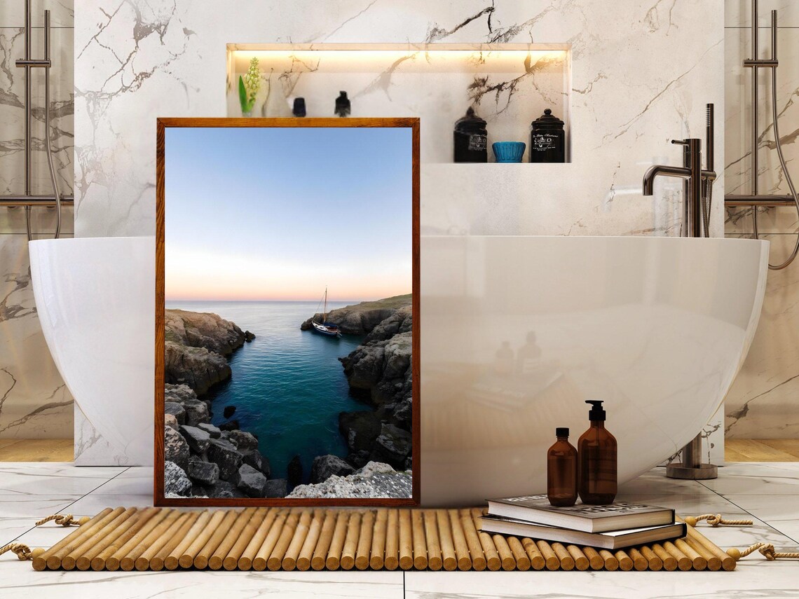 Lone Sailboat Anchored in a Rocky Coastal Cove at Dusk Poster - Image 2
