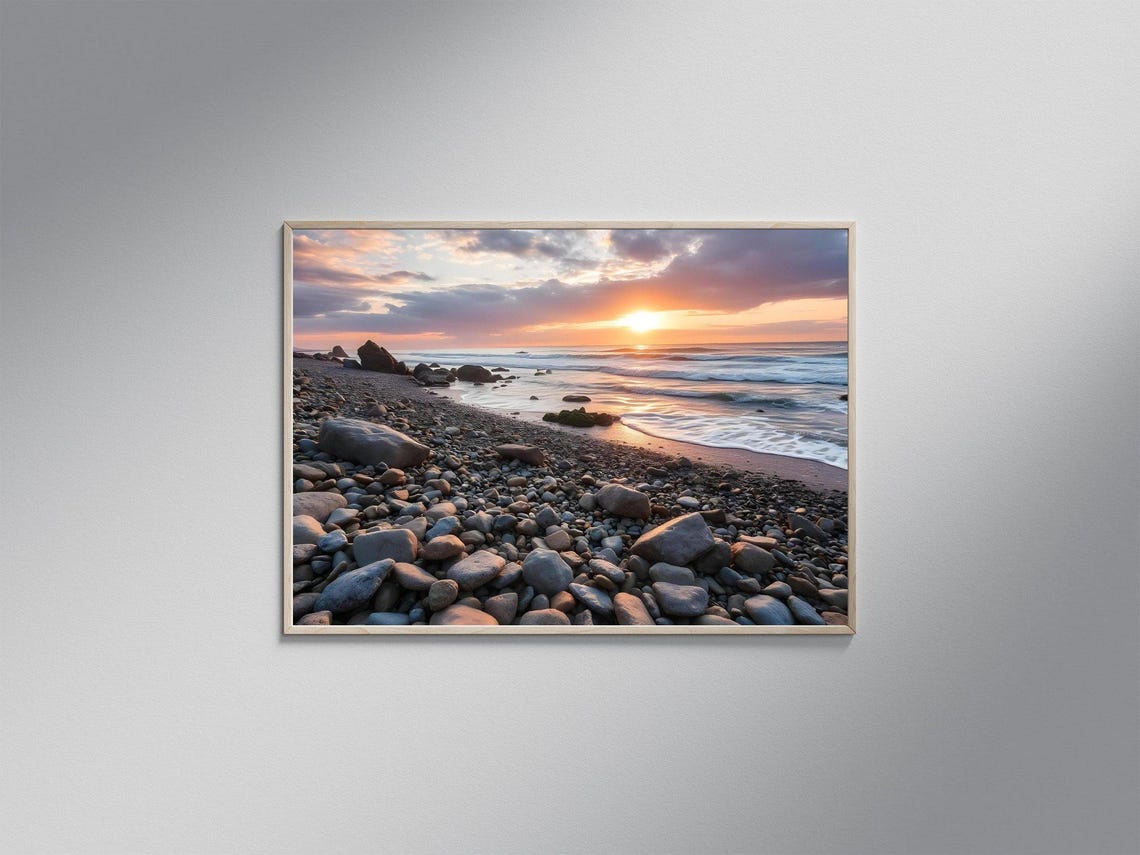Sunset Over a Rocky Pebble Beach with Rolling Ocean Waves Poster