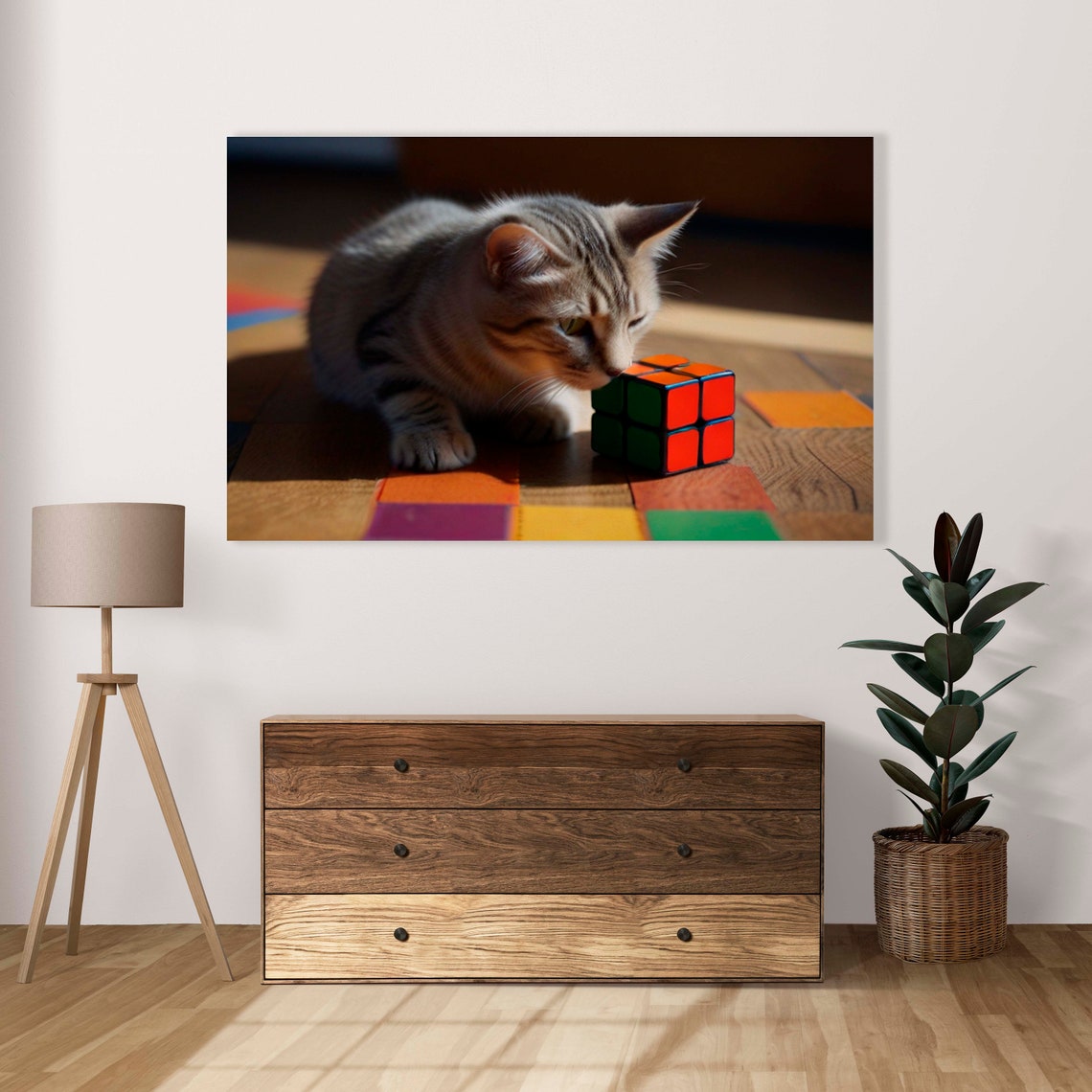 Gray Tabby Kitten Resting Beside A Small Red Rubiks Cube Poster