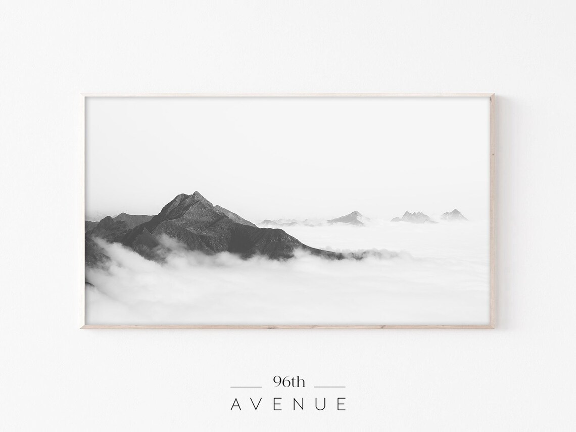Serene Black and White Mountain Peaks Above Sea of Clouds Poster