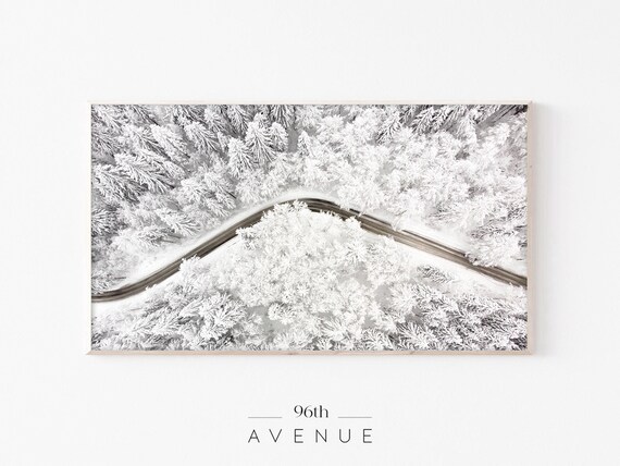 Aerial View of Winding Road Through Snow Covered Forest Poster