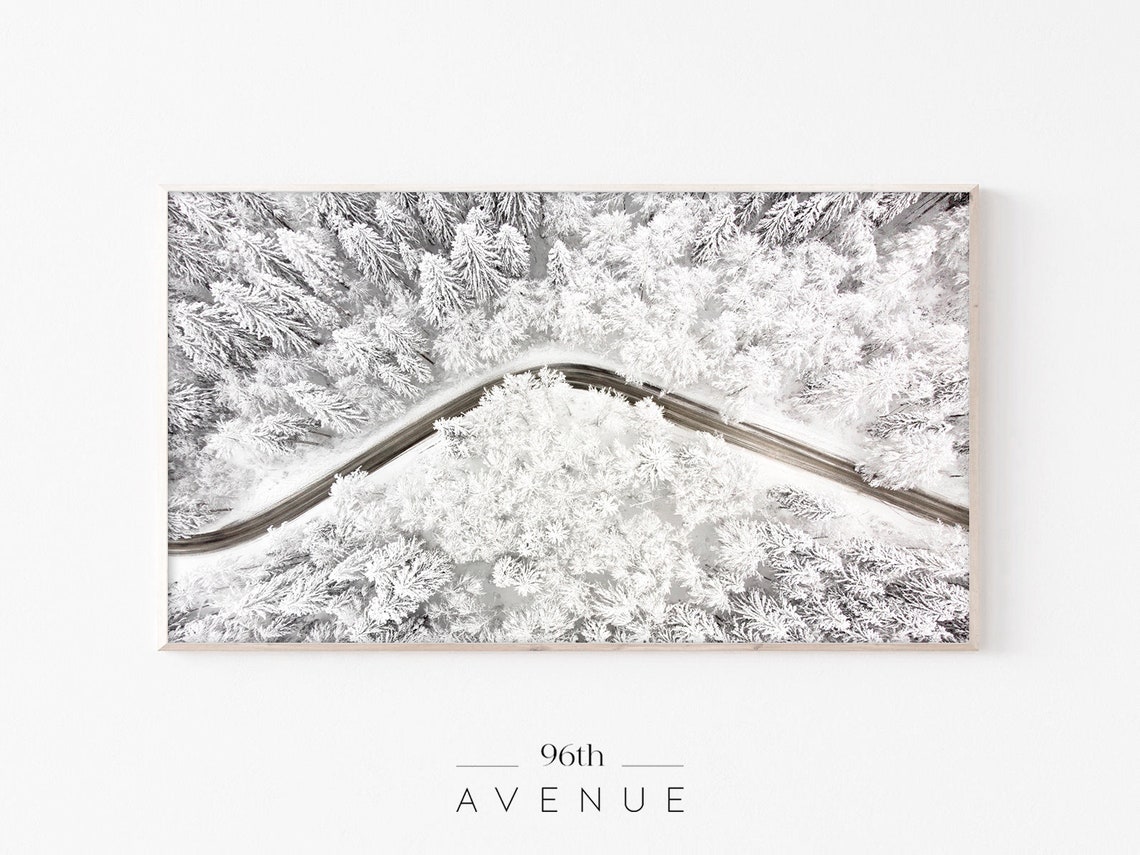 Aerial View of Winding Road Through Snow Covered Forest Poster
