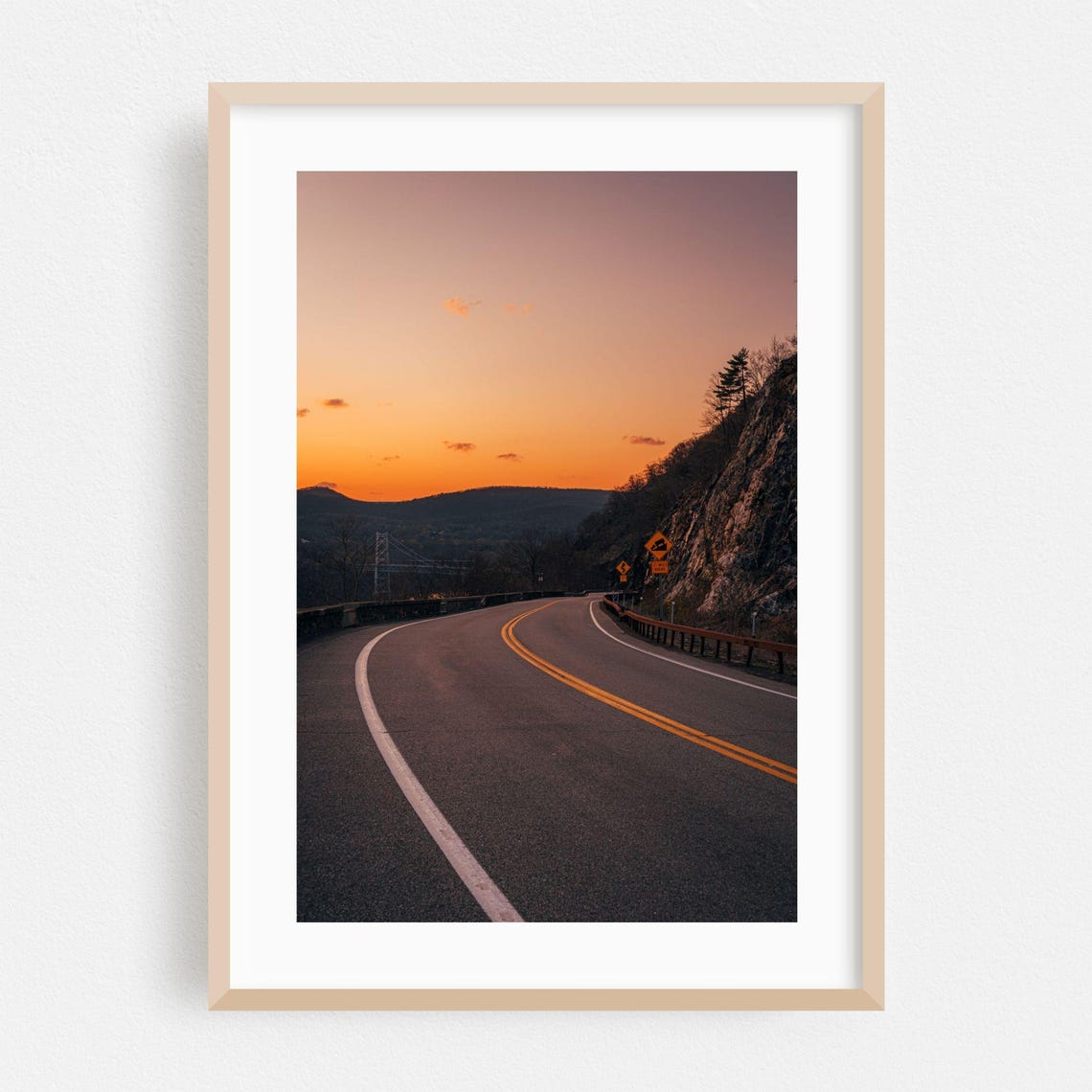 Winding Mountain Road Curving Toward Glowing Orange Sunset Sky Poster