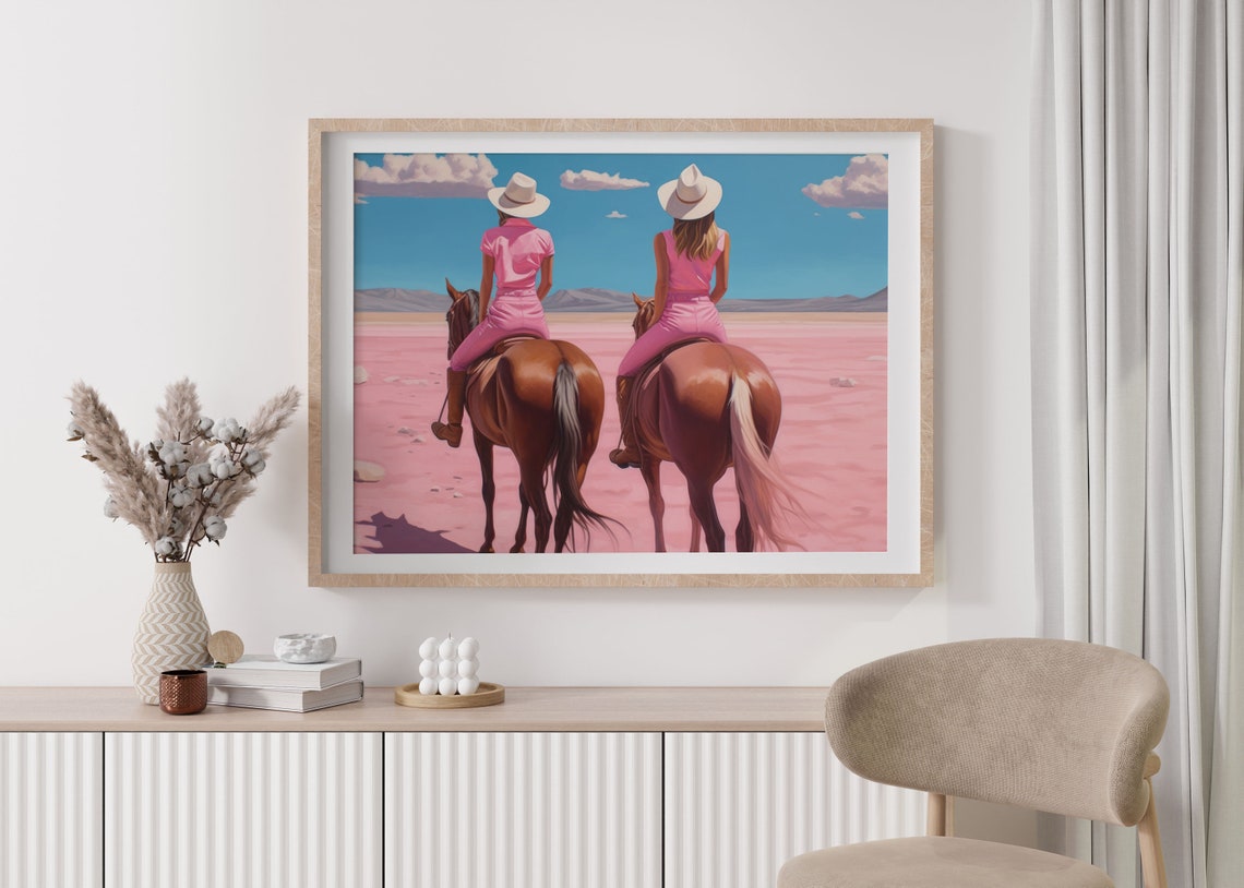 Two Cowgirls Riding Horses Across A Dreamy Pink Desert Poster - Image 3