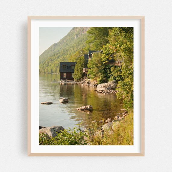 Lakeside Cabin Beneath Forested Mountain At Golden Hour Poster