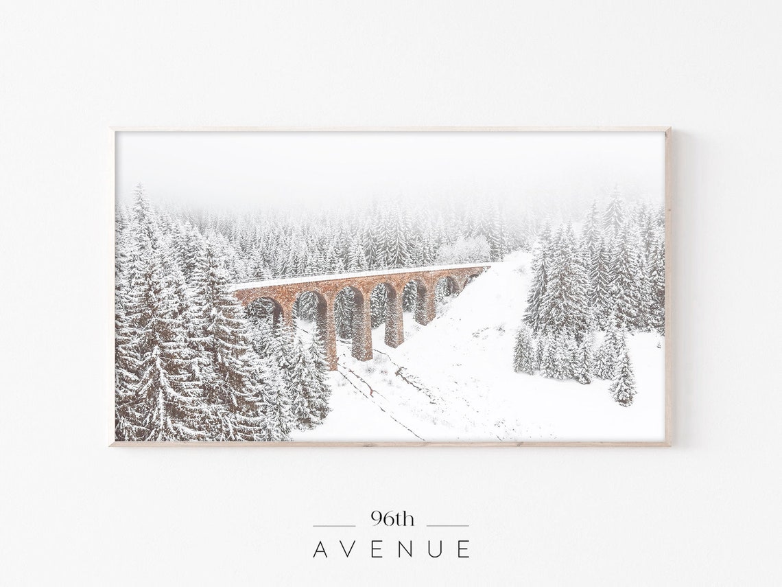 Red Stone Railway Viaduct Crossing a Snowy Pine Forest Poster