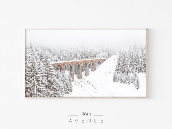 Red Stone Railway Viaduct Crossing a Snowy Pine Forest Poster