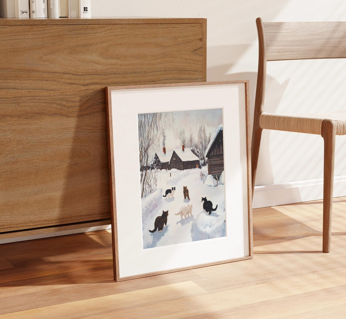Five Cats Walking Through Snowy Village Toward Cabins Poster