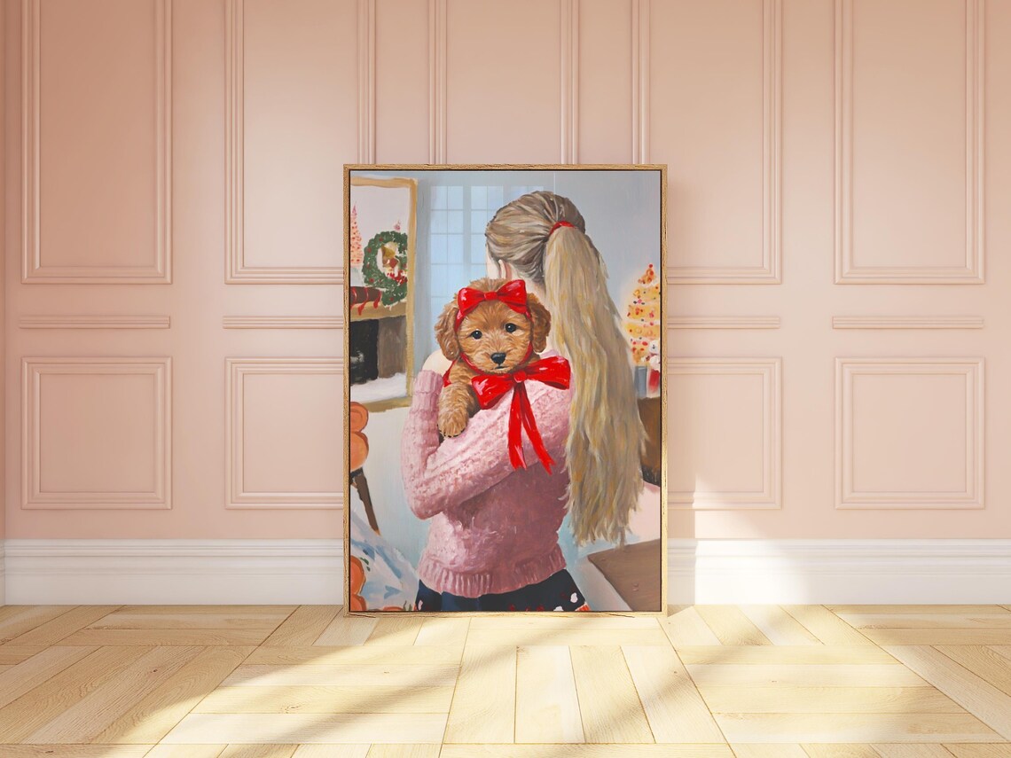 Girl Holding Goldendoodle Puppy with Red Bow by Fireplace Poster