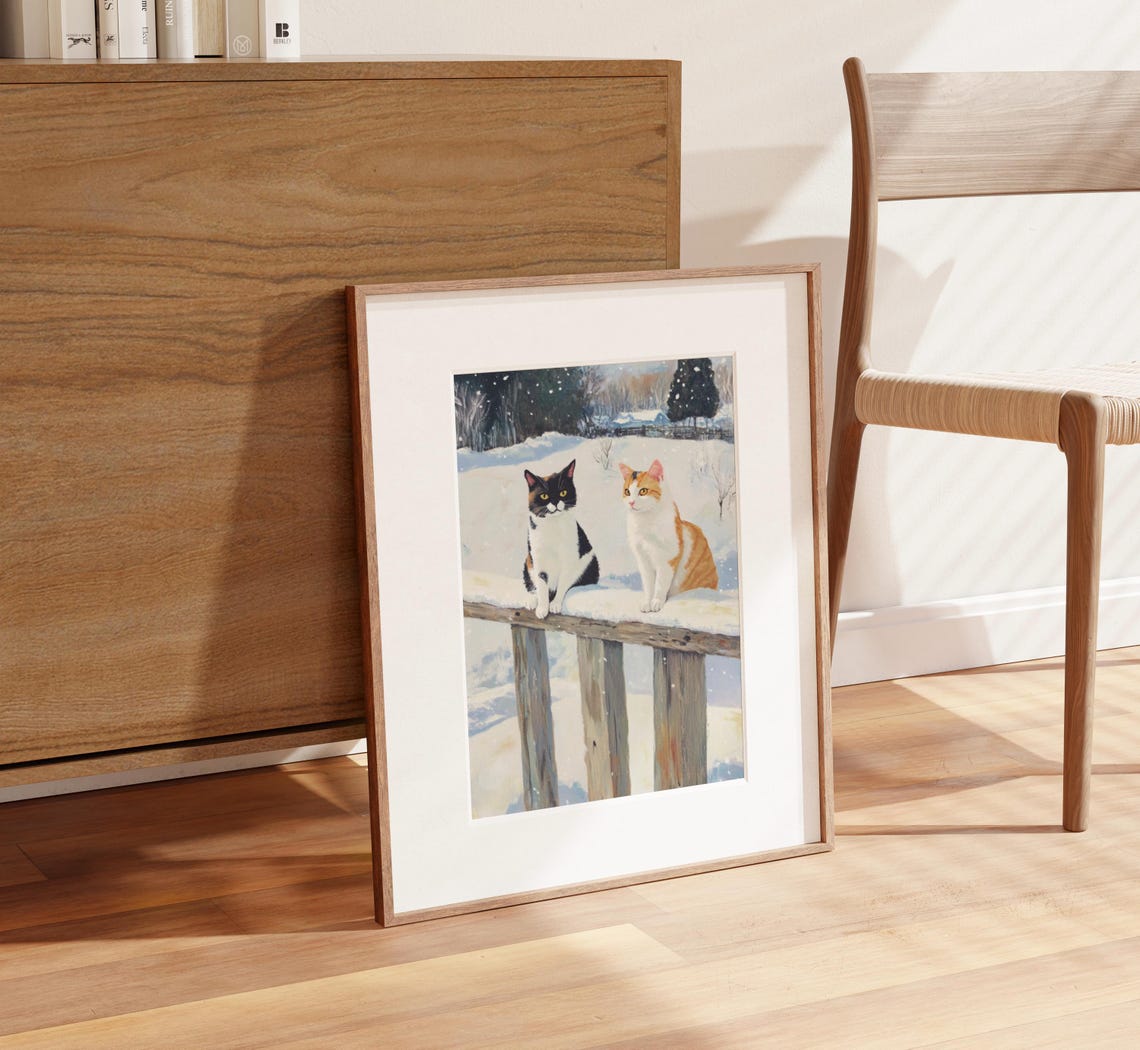 Two Cats Sitting on a Snow Covered Fence in Winter Village Poster