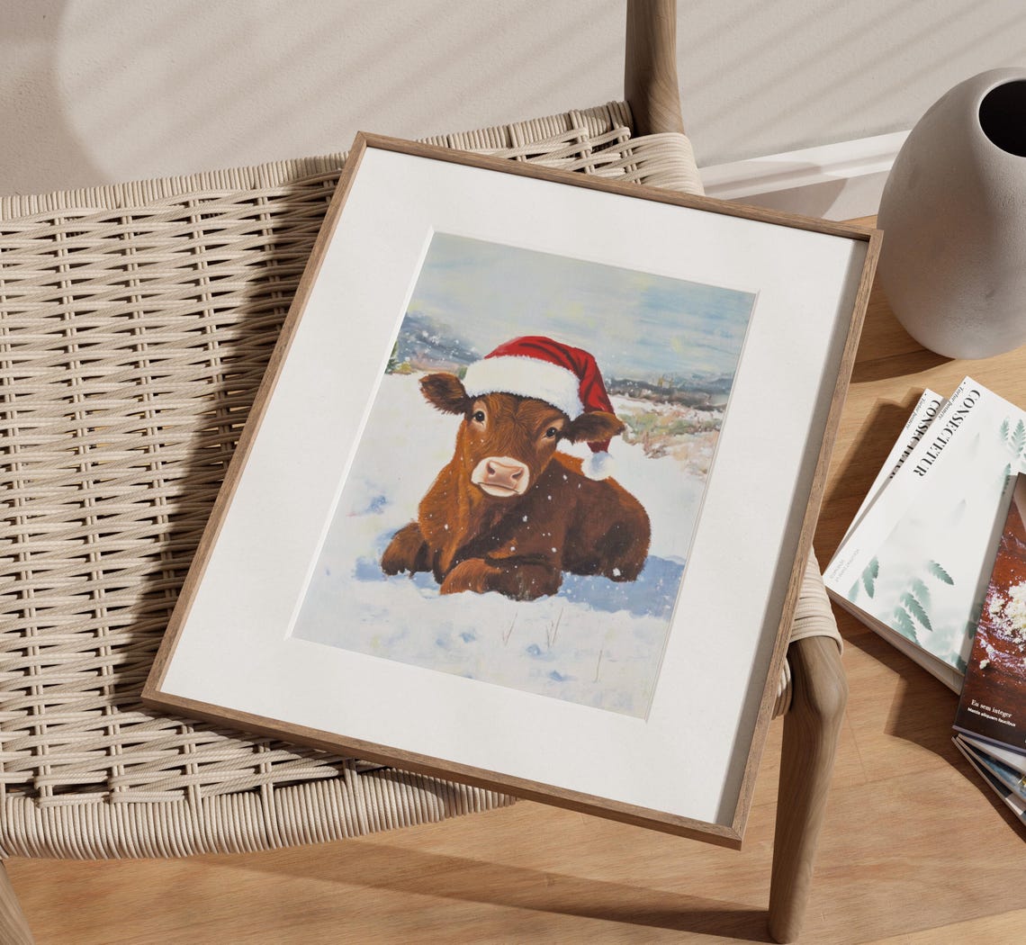 Baby Brown Cow Wearing Santa Hat in a Snowy Field Winter Poster - Image 2